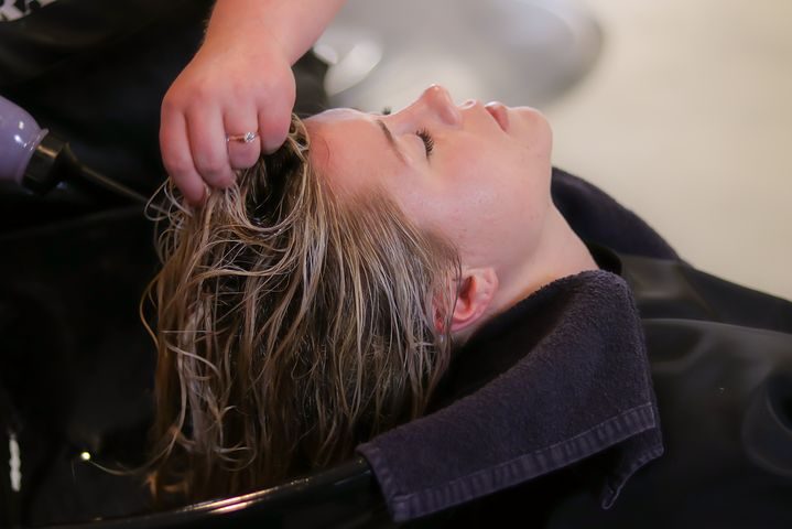woman getting hr hair washed inside a salon